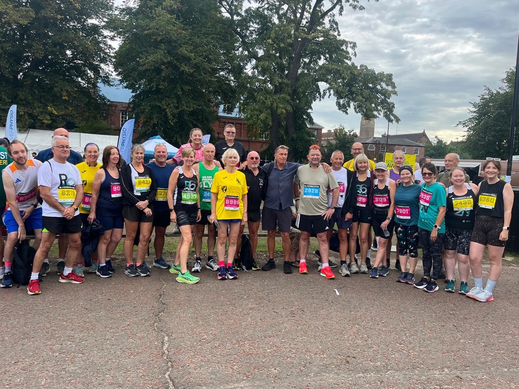Large Norfolk Run Collective group in race bibs after a city event